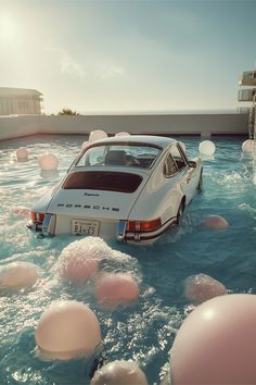 a car is in the water surrounded by balloons