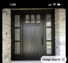 a black front door with glass on the side and an image search button below it