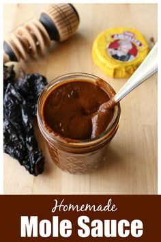 homemade molasse sauce in a glass jar with spoon and honeycombs on the side