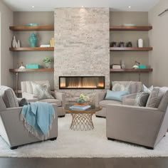 a living room with two couches and a fire place in the middle of it