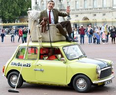 a man sitting on top of a small car