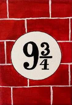 a red brick wall with a white and black number nine painted on it