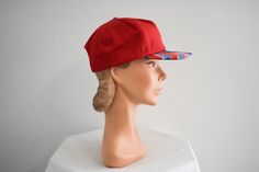 "Vintage 1980s/90s red ball cap with a patterned brim. Made by San Sun. Cotton canvas, with a back plastic adjustable band. The brim is 2.5\" wide at the center front, the crown is 6\" from the edge to the center, and the interior circumference is 20.5 - 22.25\". In good condition, with no holes or stains. The interior sweatband is dingy.  ---> If you need an order shipped by a particular date or shipped via a quicker method, please ask PRIOR to purchase to see if we can accommodate that request Retro Visor Snapback Hat One Size Fits Most, Red Snapback Visor Hat For Summer, Retro Adjustable Snapback Baseball Cap, Retro Adjustable Flat Bill Baseball Cap, Retro Baseball Cap With Visor, Retro Adjustable Snapback Cap, Retro Red 5-panel Hat, Retro Adjustable Visor Hat, Red Retro 5-panel Hat