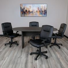 an office table with four black chairs and a painting on the wall above it that reads cityscape