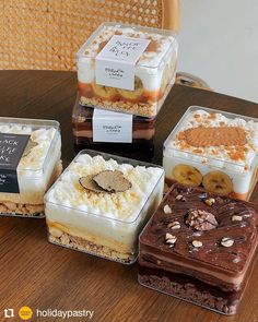 four different desserts sitting on top of a wooden table