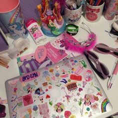 the desk is cluttered with various items such as pens, pencils and markers