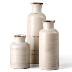 three white vases sitting next to each other