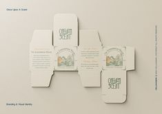 an assortment of business cards and envelopes are displayed on a white surface with green lettering