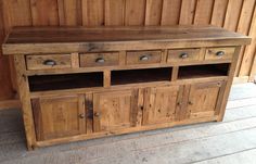 a large wooden cabinet with drawers on top