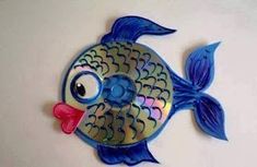 a blue and yellow fish shaped object on a white surface