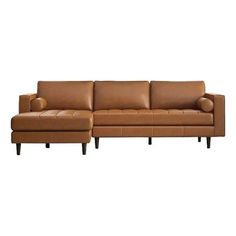 a brown leather sectional sofa sitting on top of a white floor