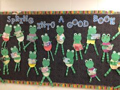 a bulletin board with frogs on it that says spring into a good book