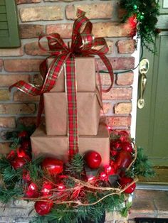 a stack of presents sitting on top of a christmas wreath