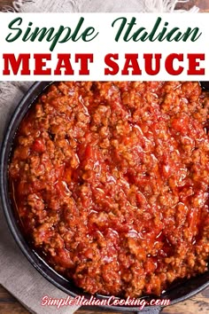 a skillet filled with meat sauce on top of a wooden table