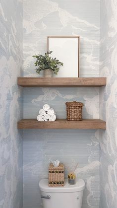 two shelves above a toilet in a bathroom