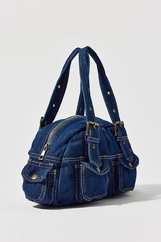 Essential denim bag from BDG with Y2K styling. Duffle style with a zippered top and snapped pouch pockets. Trimmed with a heart-shaped mirror charm and finished with a riveted adjustable shoulder strap. Only at Urban Outfitters. Features BDG denim duffle shoulder bag Denim 2000s bag from BDG Small size bag that fits the everyday essentials Plenty of pockets for storage Zipper closure with an adjustable strap UO exclusive Content + Care 100% Cotton Spot clean Imported Size Dimensions: 12.99" l x Bag Out Of Jeans, 2000s Bags, 2000s Party, Women Christmas Gifts, Bday List, Checkbook Covers, Shaped Mirror, Men's Shoes Accessories, Denim Purse