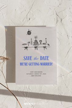 a save the date card sitting on top of a table