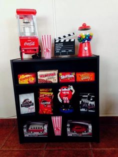 a shelf filled with different types of toys and candy on top of eachother