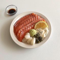 a white plate topped with fish and vegetables