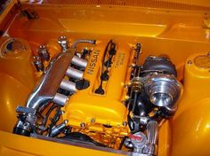 the engine compartment of an old yellow car