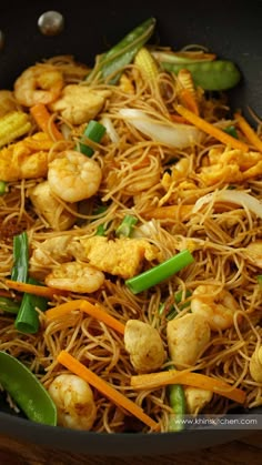 stir fried noodles with shrimp and vegetables in a wok