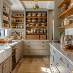 a kitchen filled with lots of wooden shelves