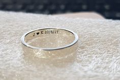 a silver ring with the word i love you written in cursive writing on it