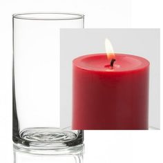 a red candle sitting in front of a glass vase