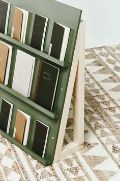 there are many books on the shelf in front of the carpeted floor and rug