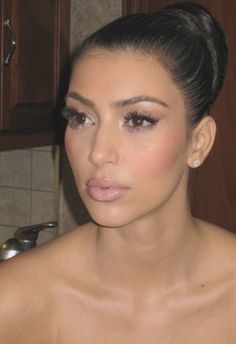 kim kardash is posing for the camera in her kitchen