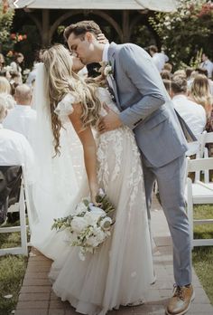 a bride and groom kissing at their wedding