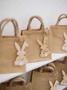 some bags with bunny ears on them are sitting on the shelf in front of each other