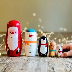 a group of wooden toys sitting on top of a wooden table next to each other