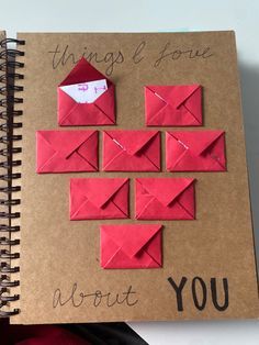 an open notebook with red origami pieces on it and the words things i love about you