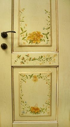 the door is painted with yellow flowers and green leaves on it's side panel