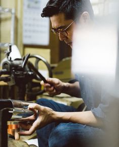 a man is working on something in his workshop