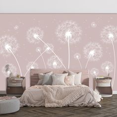 a bedroom with pink walls and white dandelions on the wall