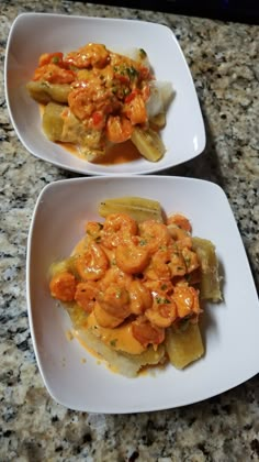 two white plates filled with food on top of a counter