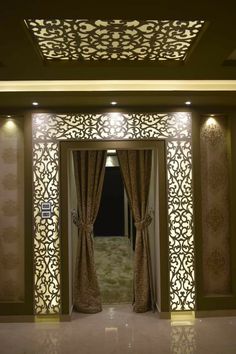 an open doorway with curtains and lights on the sides, in front of a carpeted floor