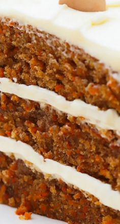 a slice of carrot cake with white frosting and an egg in the middle on a plate