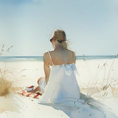 a woman sitting on top of a sandy beach next to tall grass and the ocean