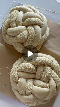 two braided breads sitting on top of a table next to each other in front of a piece of paper