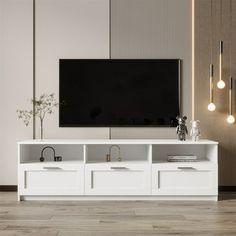 a white entertainment center with two drawers and a flat screen tv mounted on the wall