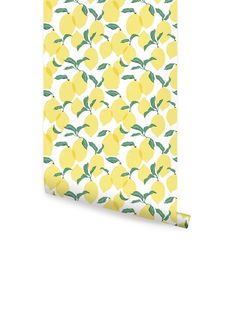 a yellow and white wallpaper with lemons printed on the front, along with green leaves