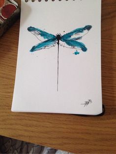 a drawing of a dragonfly sitting on top of a table