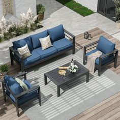 an outdoor living room with blue couches and coffee table