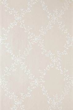 the wallpaper is white and has small leaves on it, as well as a vase with flowers in it