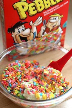 a bowl filled with cereal and sprinkles next to a box of pebble