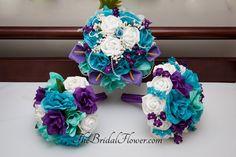 three bridal bouquets sitting on top of a table