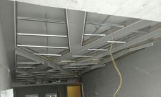 an unfinished room with metal beams and wires attached to the ceiling